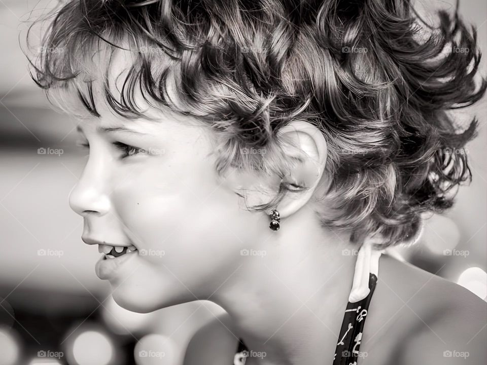 Black and white portrait of a smiling child