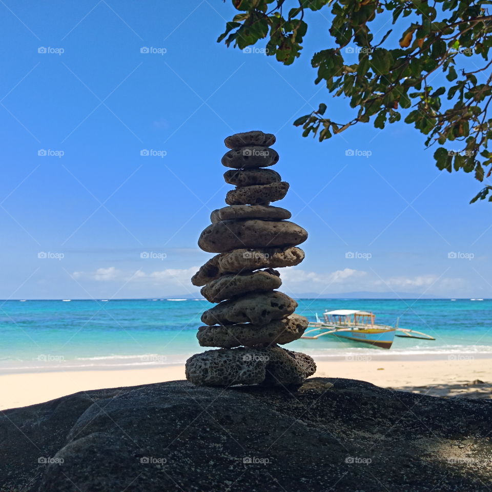 Balanced and focused!

This are rocks from the oceans balanced in a big rock in the shore.

Behind it you can see the natural blue sea and this is located in Pinamuntugan Island, Bacacay, Albay, Philippines.