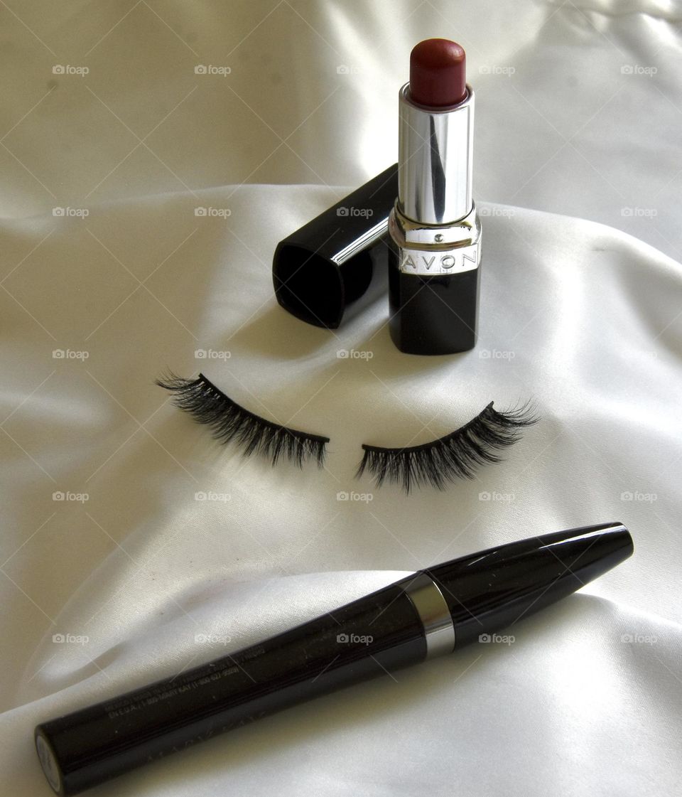Makeup still life with eye lashes and lipstick 