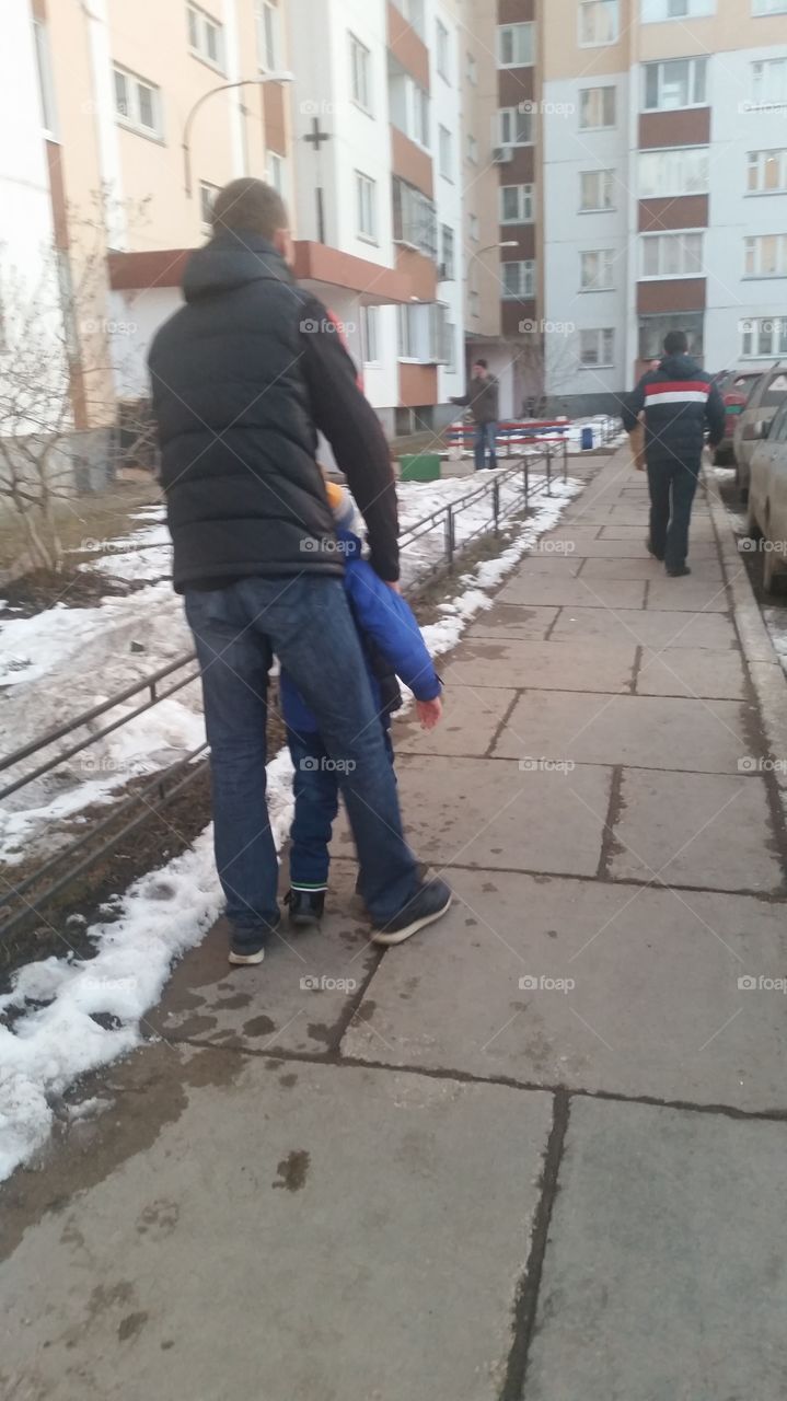 Children's cerebral palsy is not a verdict. My son can not walk yet, but we are helping him. In the photo, my husband holds his son by the arms so that he can walk.