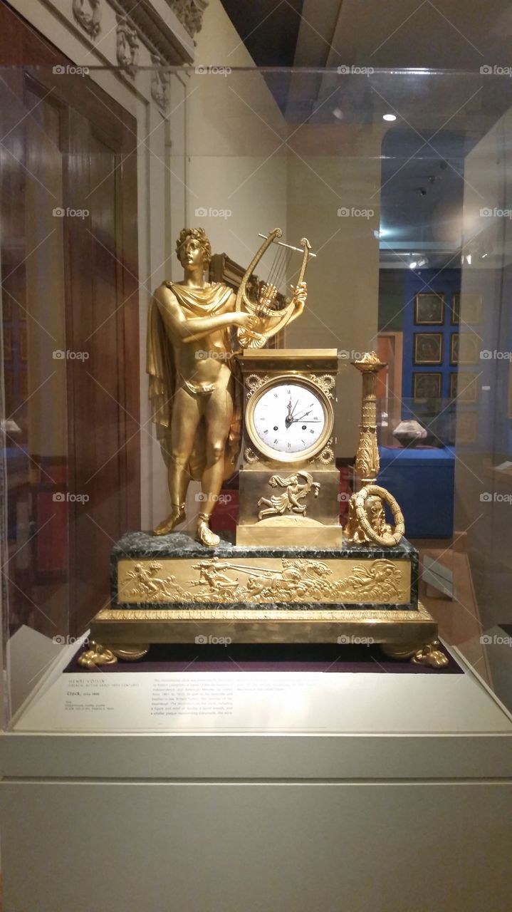 decorative gold clock with lyre