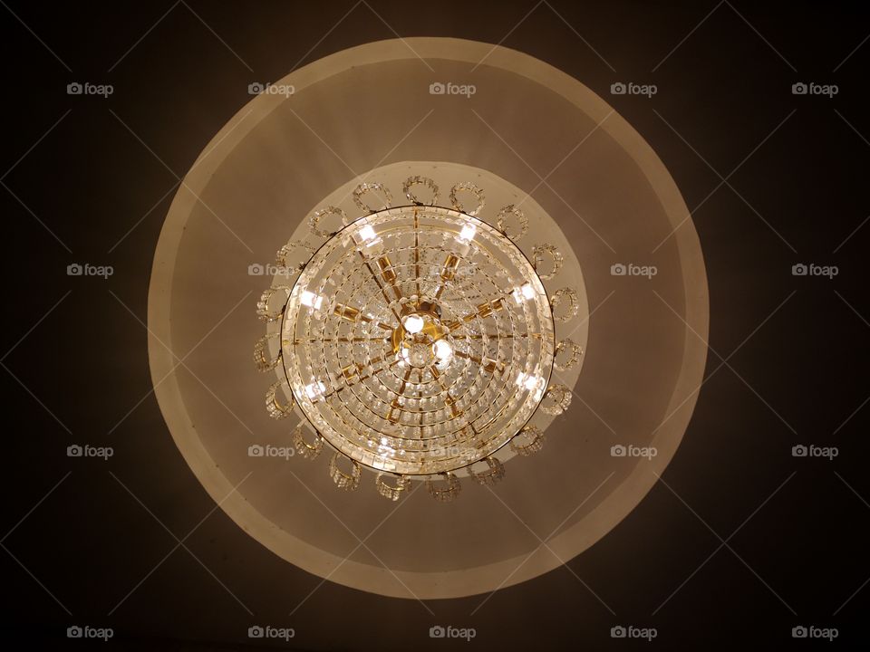 Low angle view of crystal chandeliers lighting in the night.