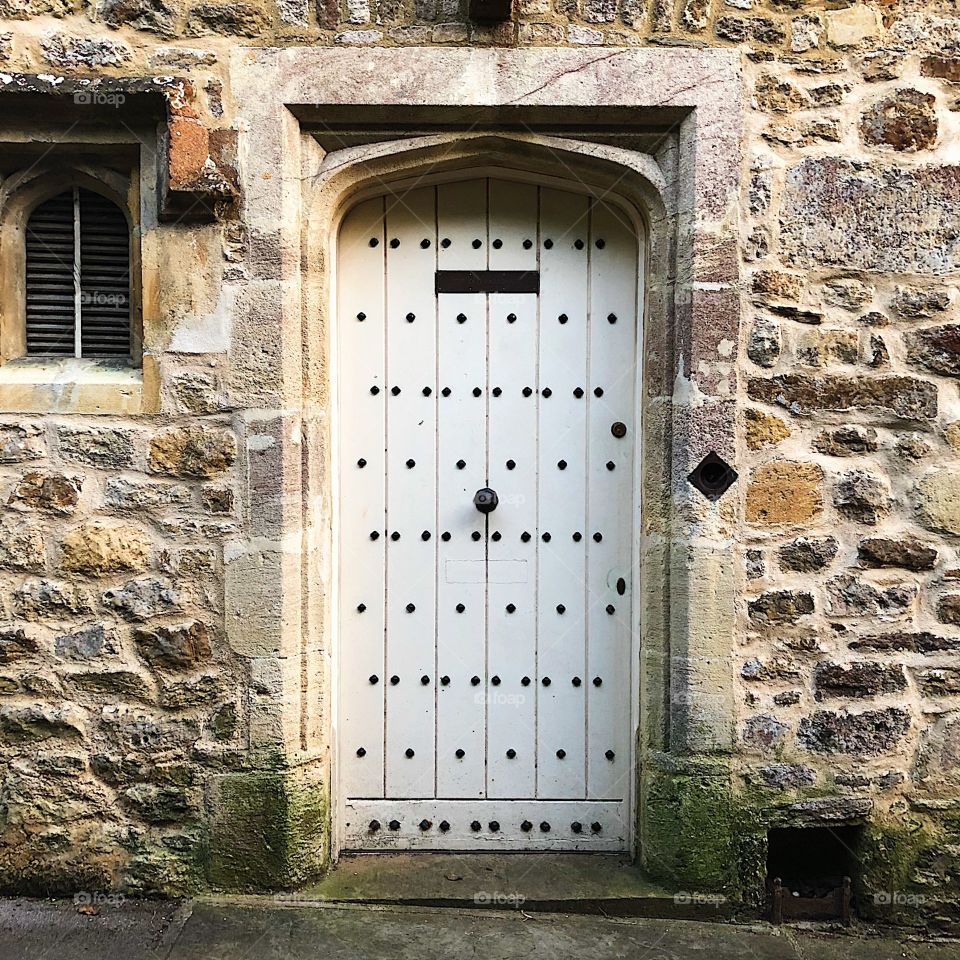 White old door in a stone building 