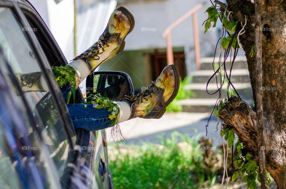 What's that doing here 😃? Woman Lying in Car With her Feet Out of Car Window. She Have Flowers Inside the Boots