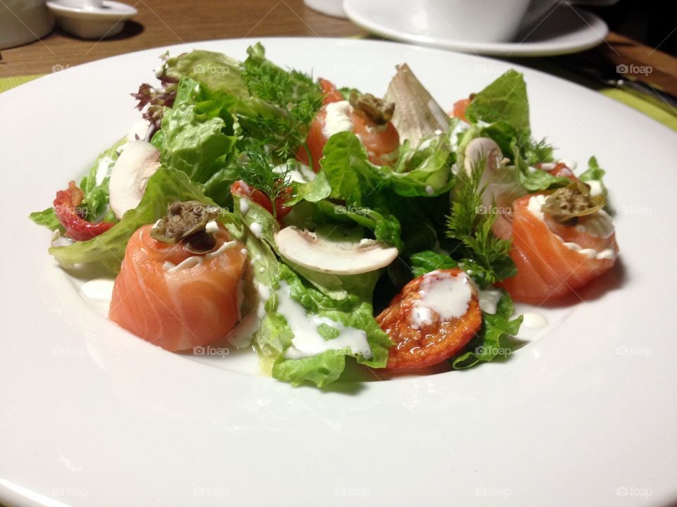 Salmon salad with vegetables on a plate 