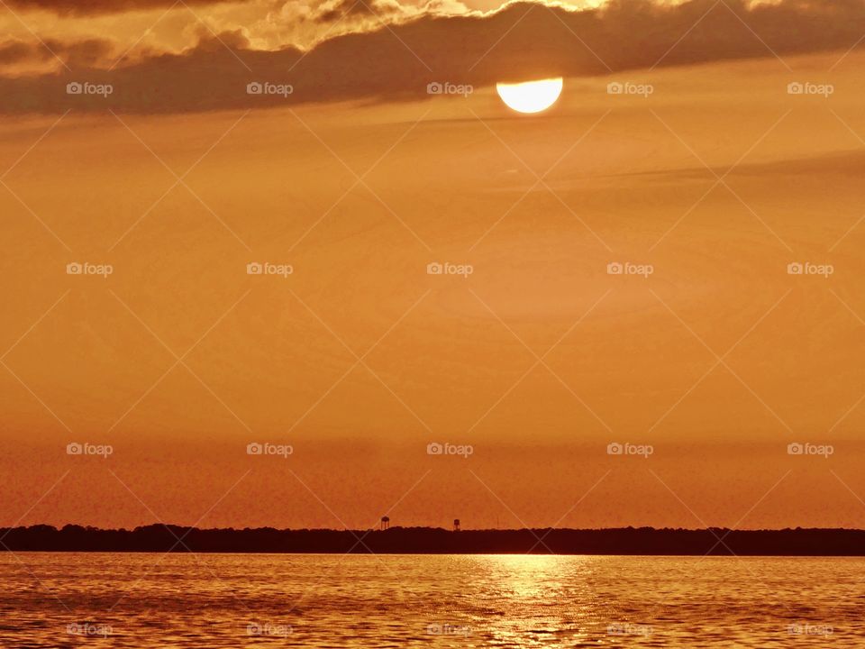 The sunset was a perfect conclusion of the day. It was silky, smooth collusion of sky burst reds, yellows, various hues, orange, tangerine and metallic gold