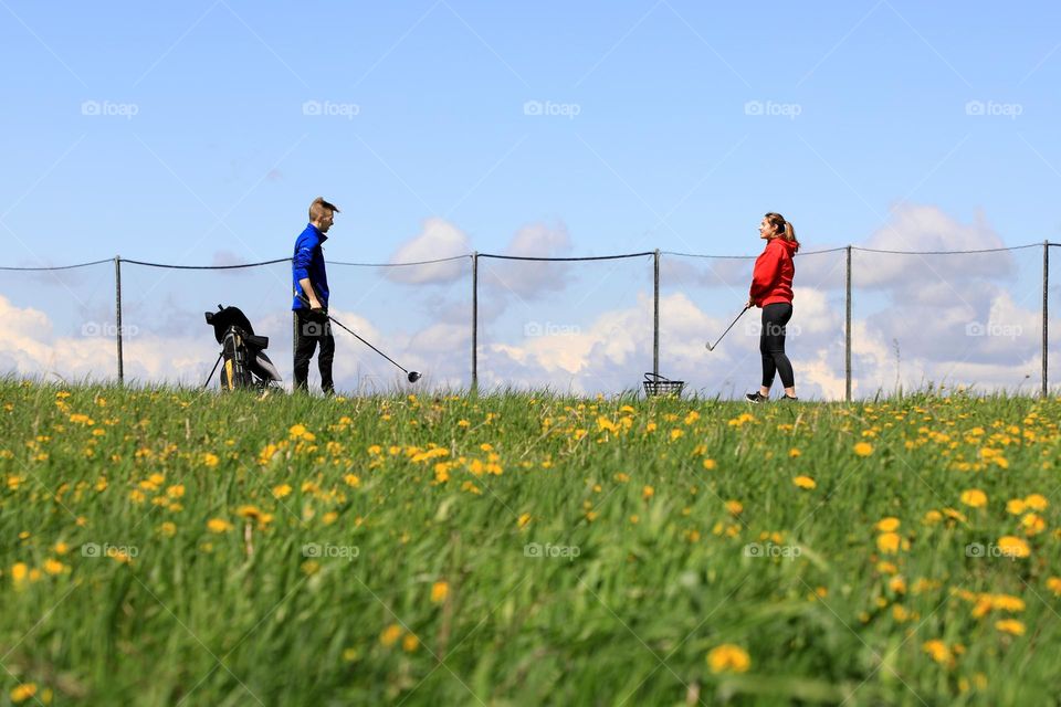 Lovers playing golf