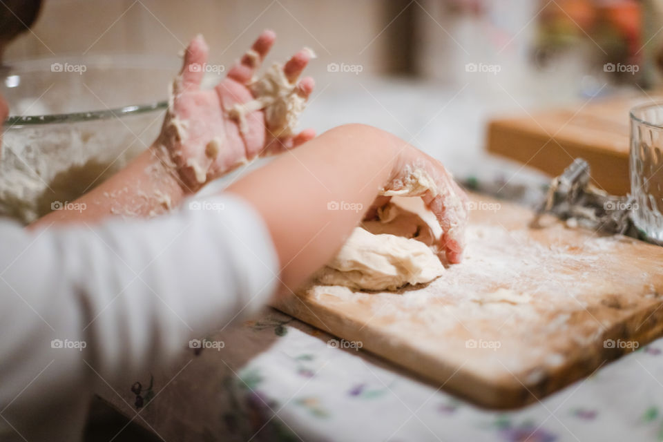 Child while playing with pasta and flour during the quarantine from Covid-19