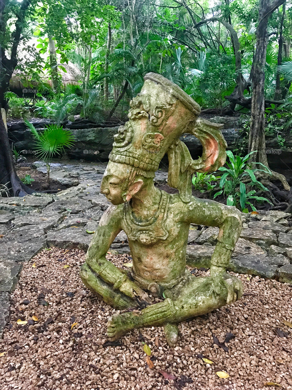 stone statue in tropical Mexican garden 