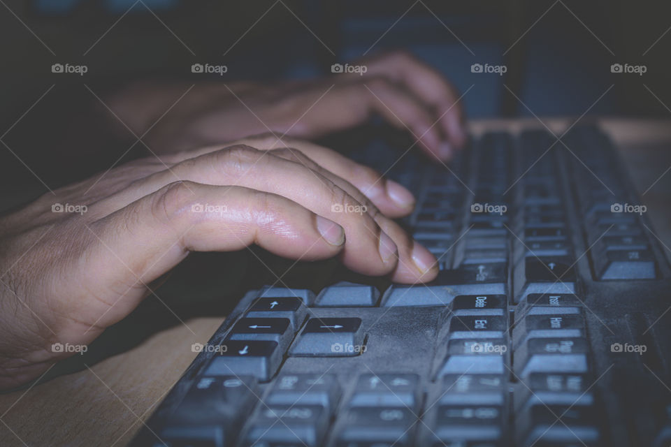 A professional person typing or using an office laptop keyboard. View of a online social media marketing executive network worker working on a desktop computer, business concept