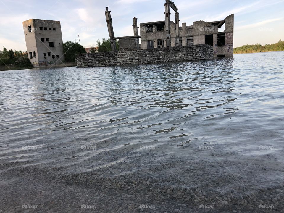 Abandoned building standing in the water