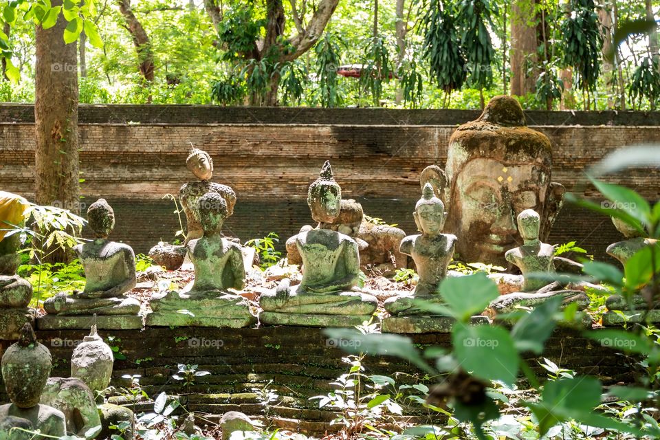 Buddhist statues in the forest by Wat Umong temple. The ancient ruins are beautiful and always make for a great photo.
