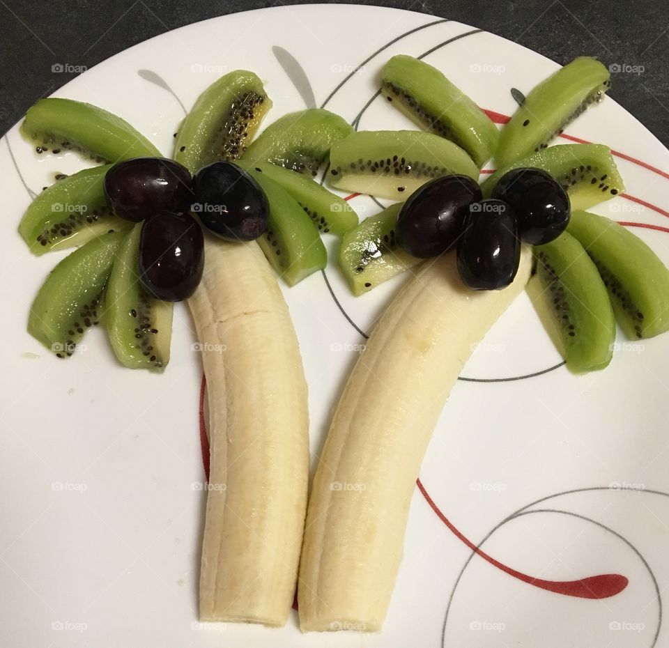 Coconut Trees made out of bananas, kiwis and grapes. Creativity at its best!