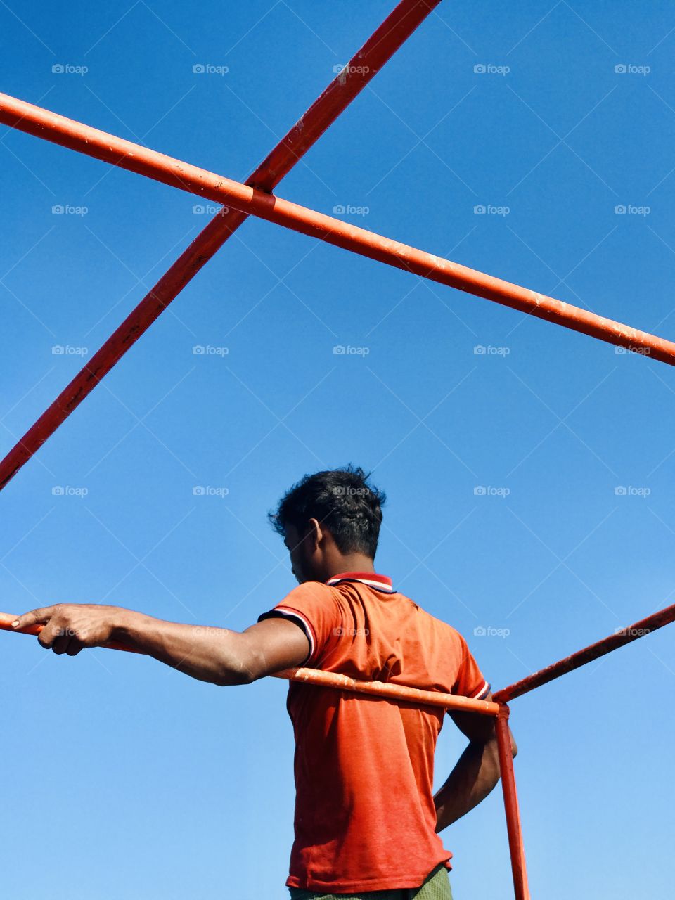 With a huge Sunny day a young boy is waiting for his destination on boat, satisfying click. 