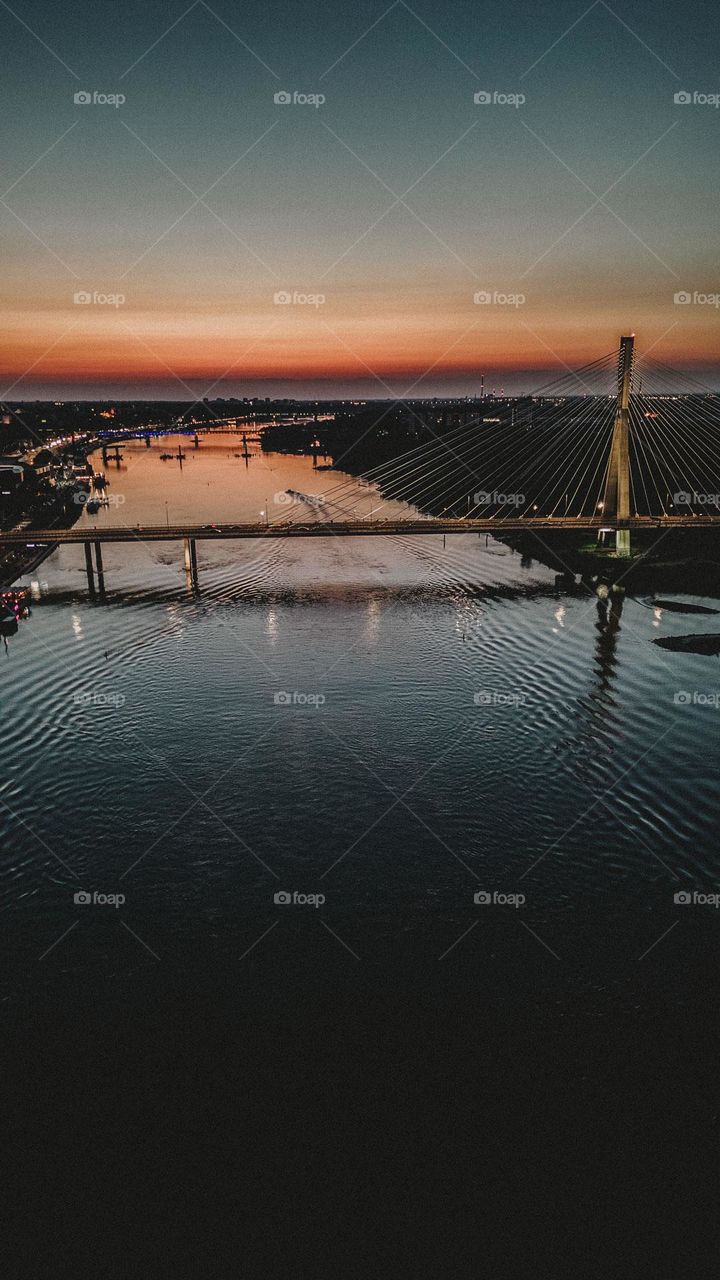 Beautiful Sunset above the river. Big bridge.