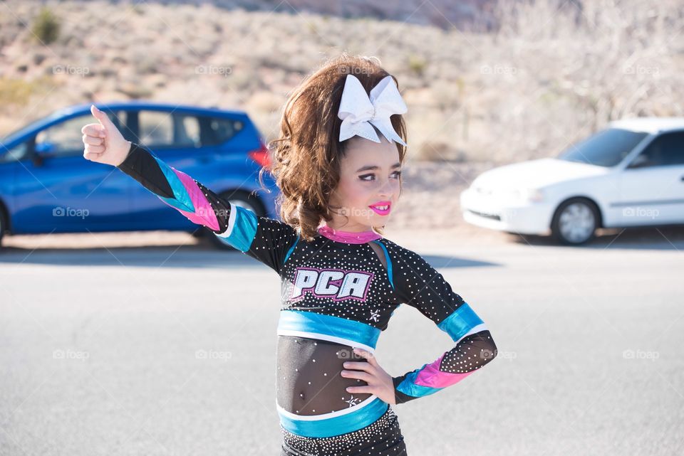 Young cheerleader girl at red Rock mountains