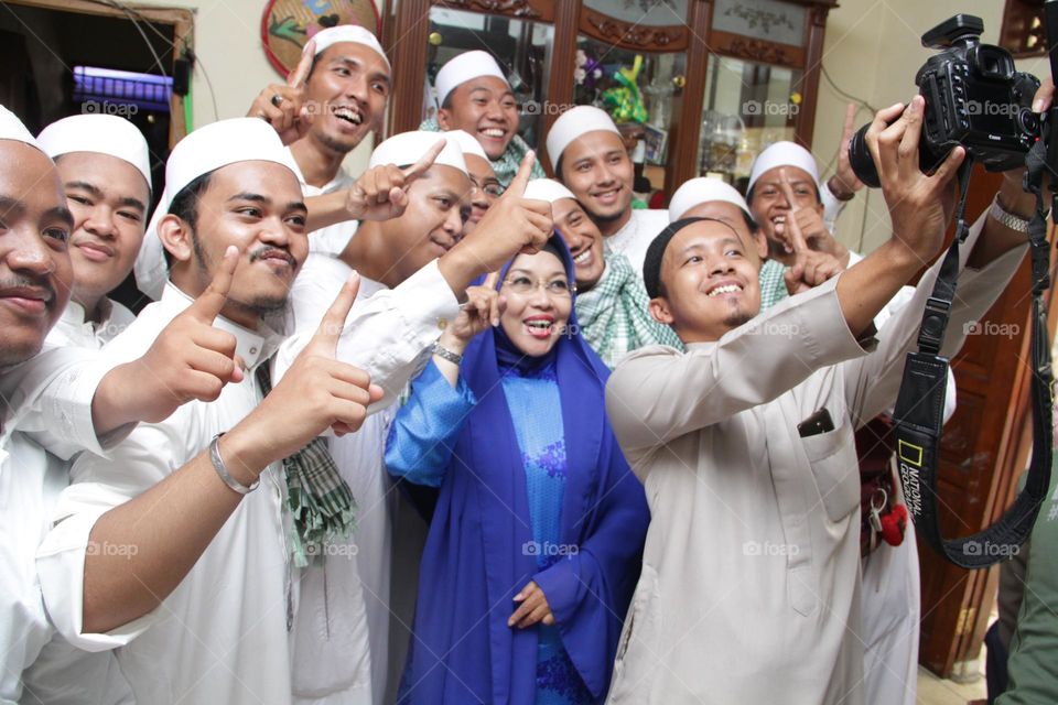 Portrait of a group of Muslims posing together with happy expressions.