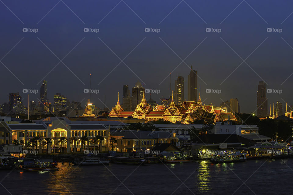 The beauty of the Golden palaces and phra keaw Temple ,The Chao Phraya River at night in Bangkok, Thailand.