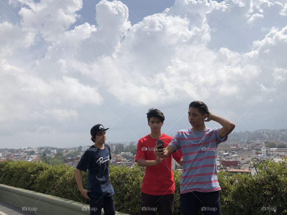 Hilltop. Brothers enjoying a beautiful day in “Palacio de Gobierno” in Xalapa. The wind the rooftops and the clouds in the background. Nature always painting a perfect picture. 