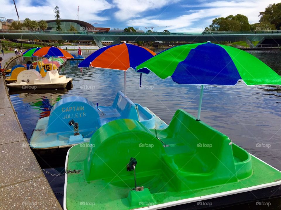 Greed paddle boat. Paddle boats with umbrellas on the River  Torrens. Adelaide. 