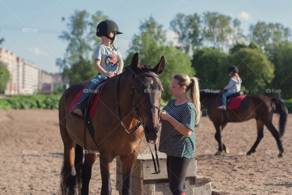 children learn to ride a horse