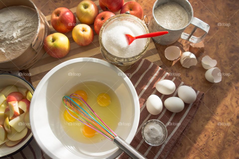 Making homemade puffed apple pie with eggs, sugar and flour.