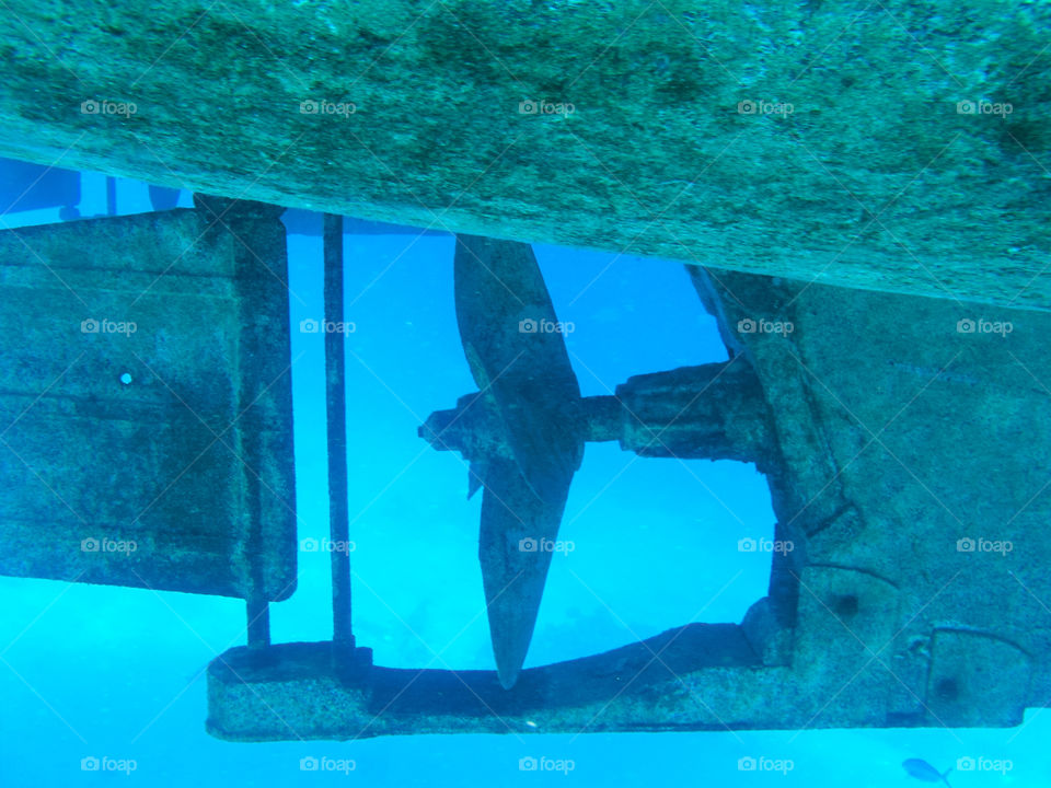 Propeller of metal boat in the red sea. Underwater picture