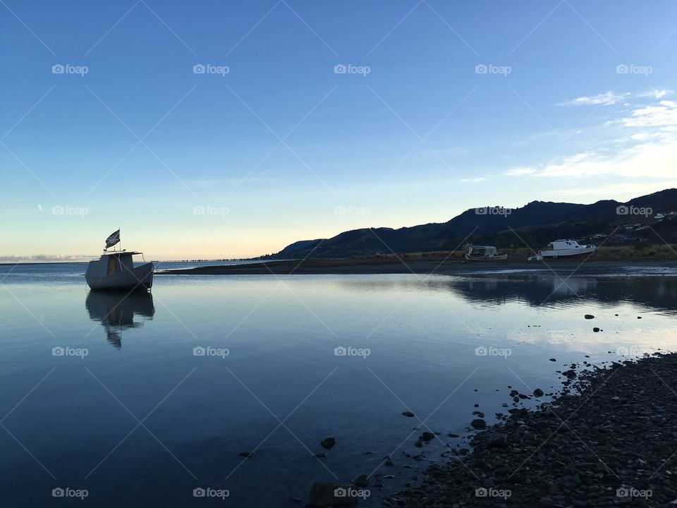 Boat on the water early morning light