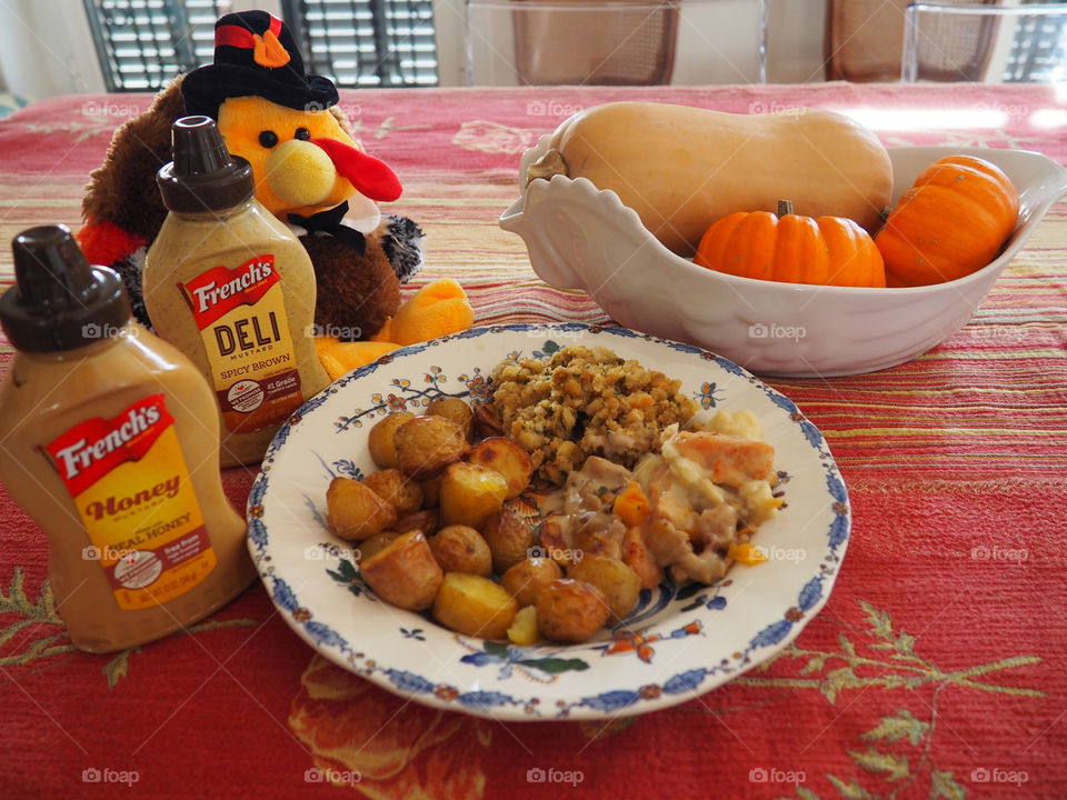 Thanksgiving plate of turkey in a creamy French’s deli and honey mustard sauce with stuffing and roasted potatoes.