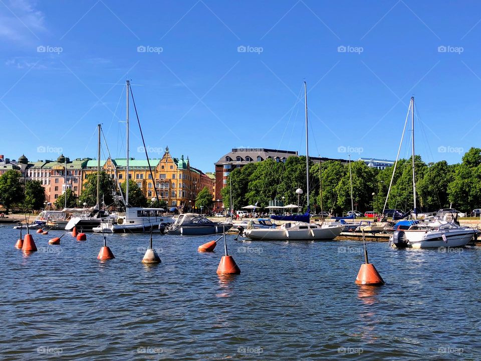 Urban nature - water: city view from the sea side with life buoys and boats