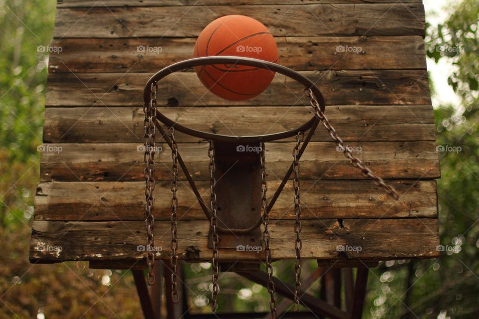 Girl throws the ball into the basketball hoop