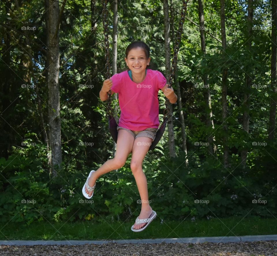 This picture is my sister on a swing at the playground. taken on a Nikon D5500.Later edited on Adobe light room