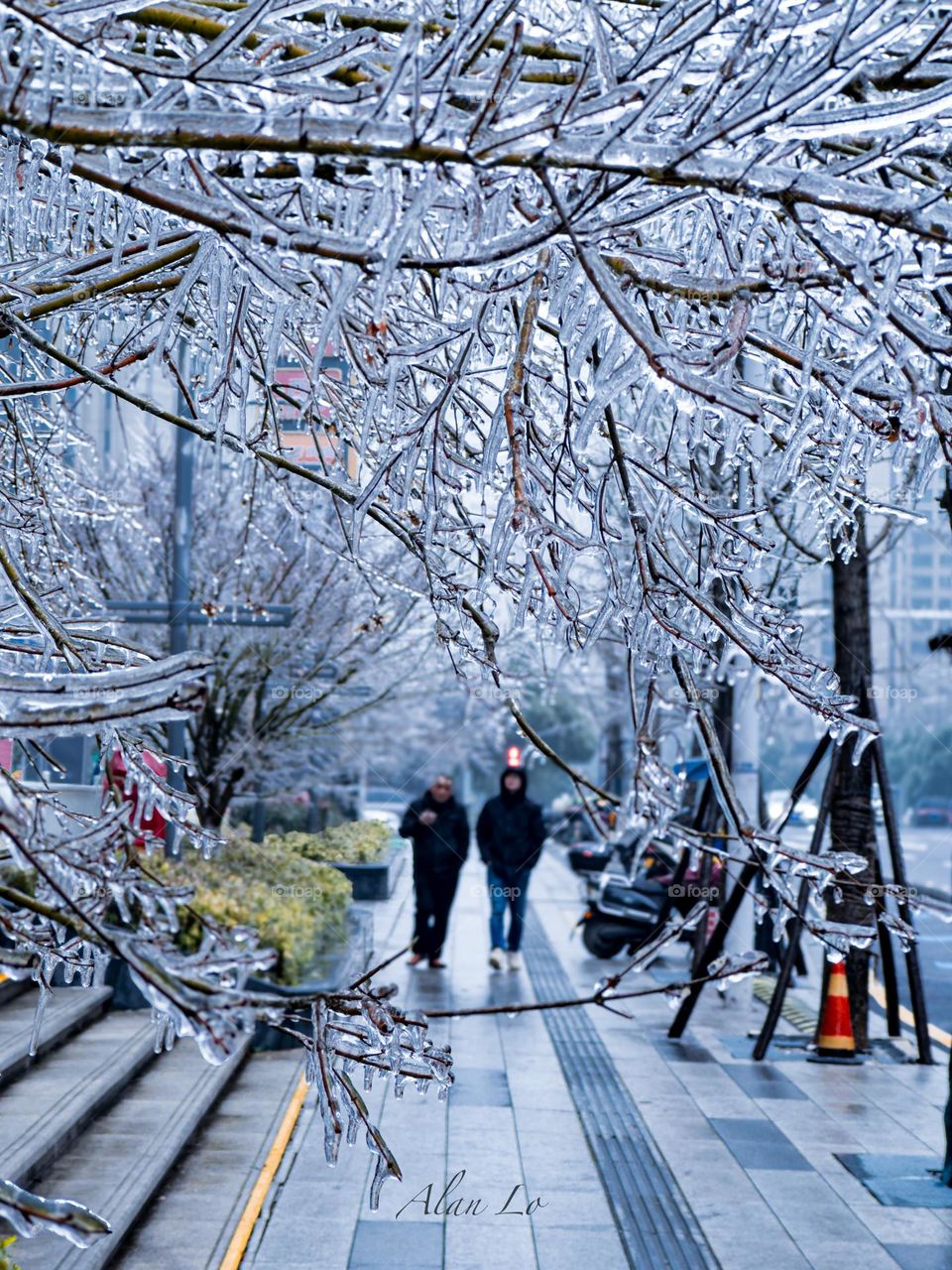 Two men walking under a frozen road