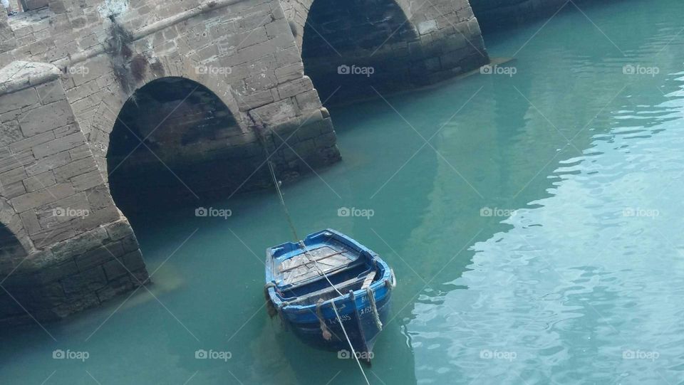 a blue boat in harbour