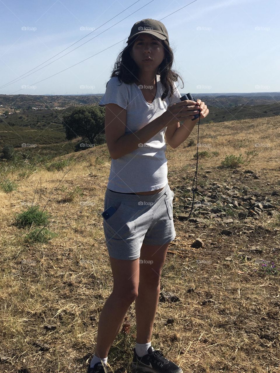 Young woman walking in countryside and observing nature