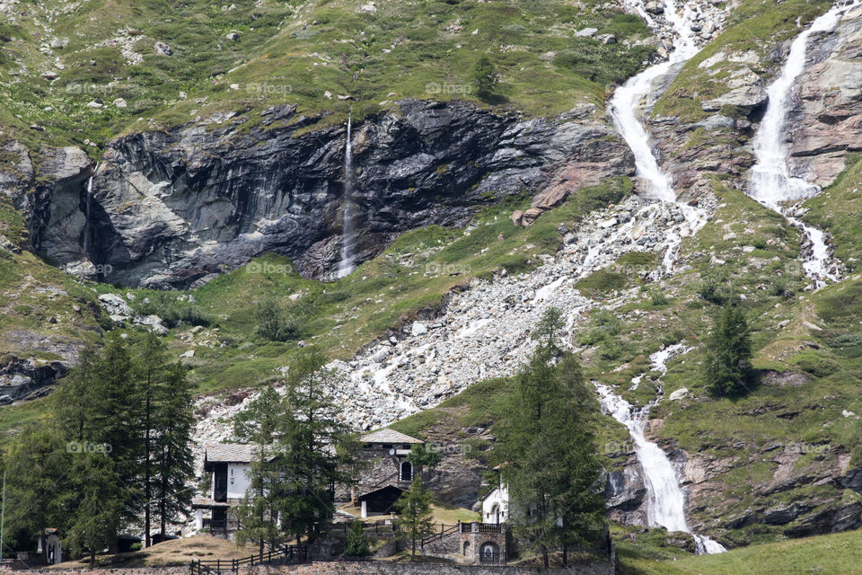 House in the mountain with waterfalls Breuil-Cervinia Italy , by the Matterhorn. Monte Cervino Italia . Hus i bergen med vattenfall Italien 
