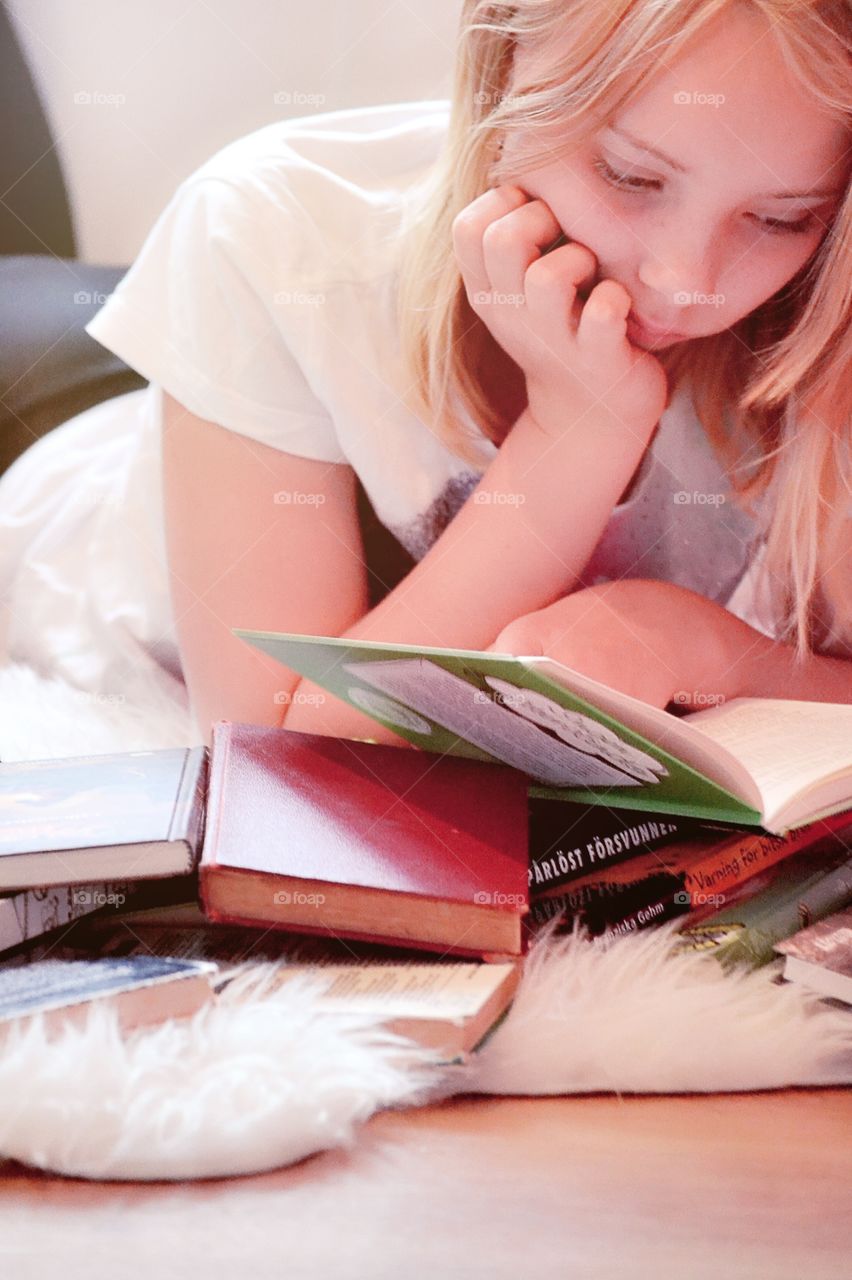 Close-up of a girl reading books