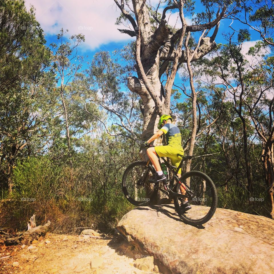 Mountain biking on a rock