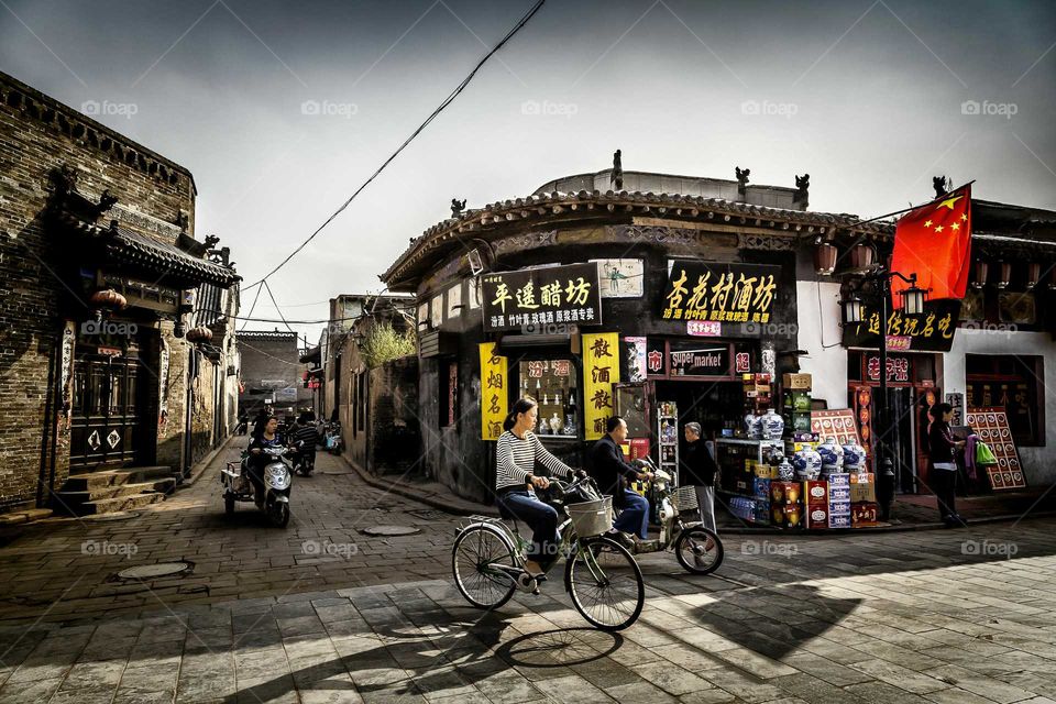 Bicycle street in Pingyao.. Beautiful village called Pingyao of these people ride cycles, tuk tuk and small three wheel motorcycle into the street.