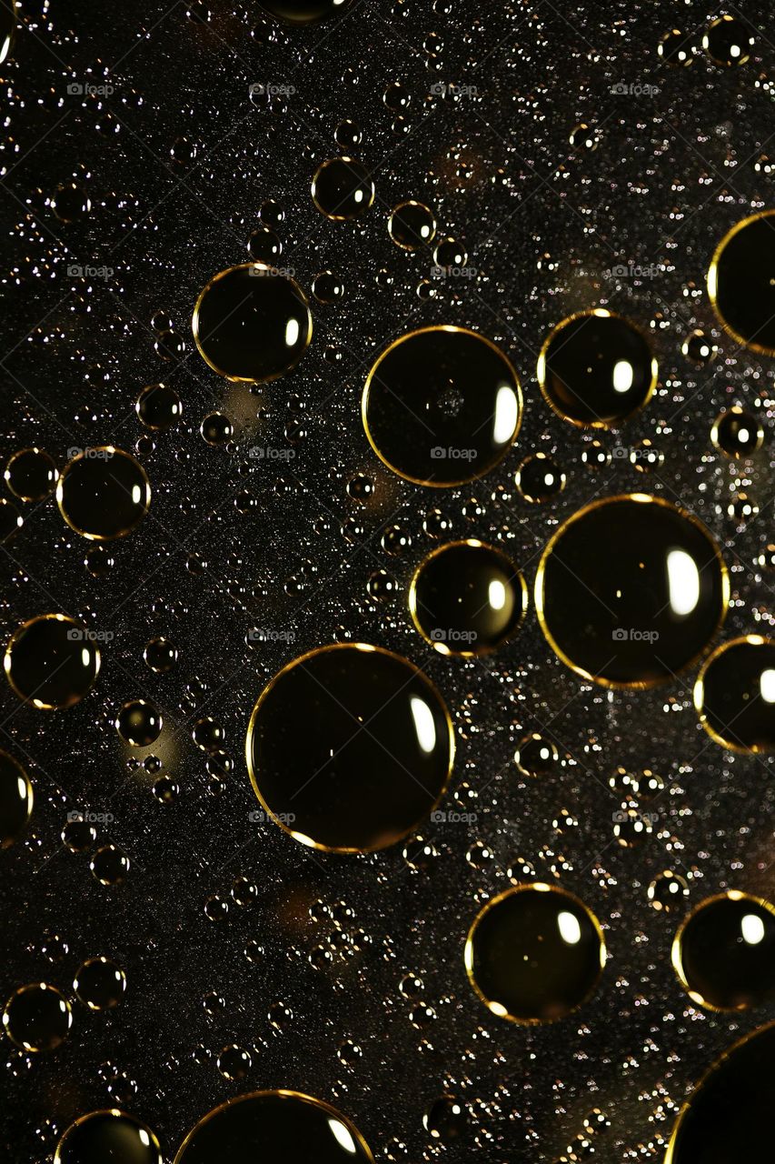 Golden oil Bubbles Close Up background amazing colours droplets of life in black texture macro look summer mood positive vibes wonderful day hustling daydreaming