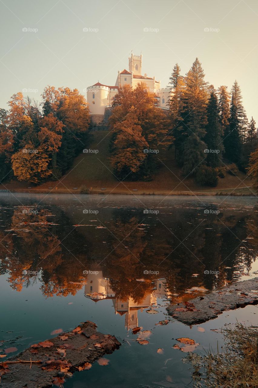 Fall at Trakošćan Castle on the hill reflected in the lake in Croatia, county hrvatsko zagorje