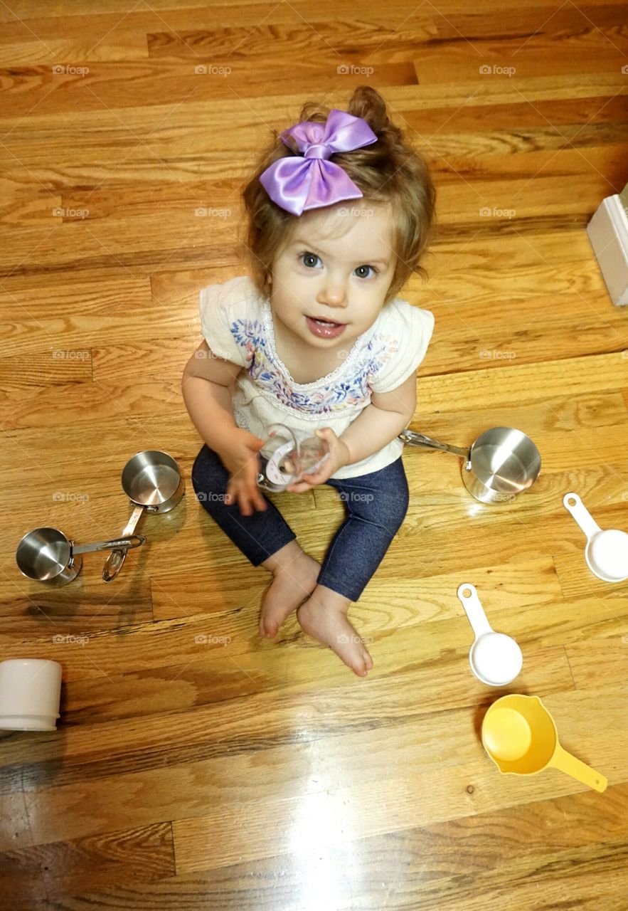 Elevated view of baby girl with measuring spoon