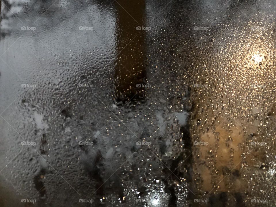 Rqaindrops dancing with the soft evening light on the window, heralding hope or sorrow, serenity or agony?