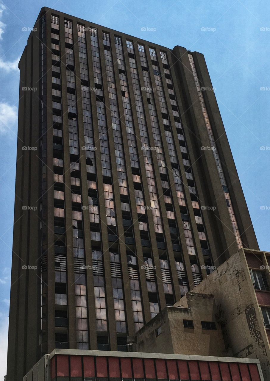 Squatter building in Johannesburg high rise broken windows 
