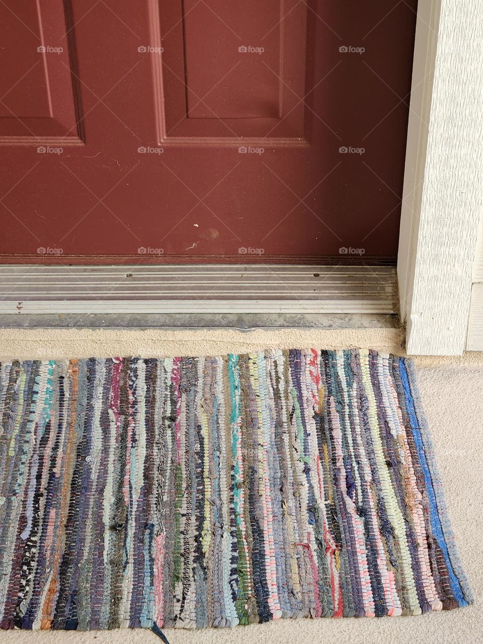 colorful striped front door welcome mat of a suburban apartment