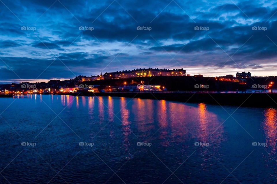 The popular town of Whitby, North Yorkshire, England, UK at dusk with