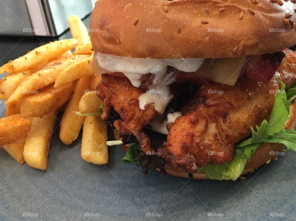 Buttermilk chicken, bacon,cheese, tomato and lettuce between buns! It’s mouth-watering!!