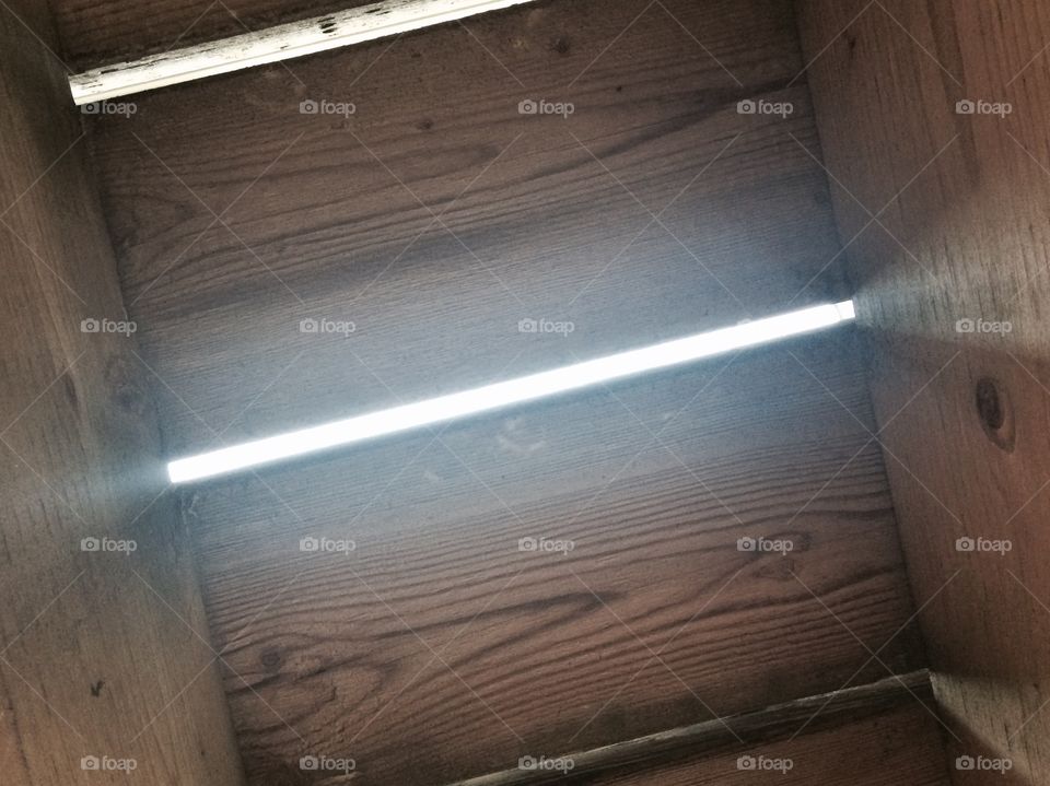 View to a bright day from down under the porch