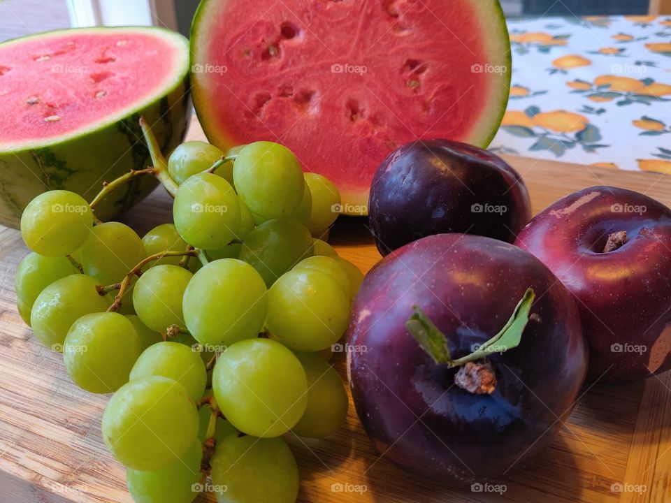 Plums, grapes and watermelon ready to eat.