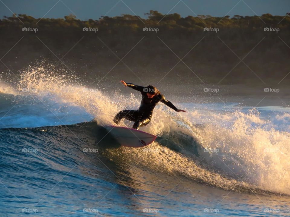 Surfing at sunset